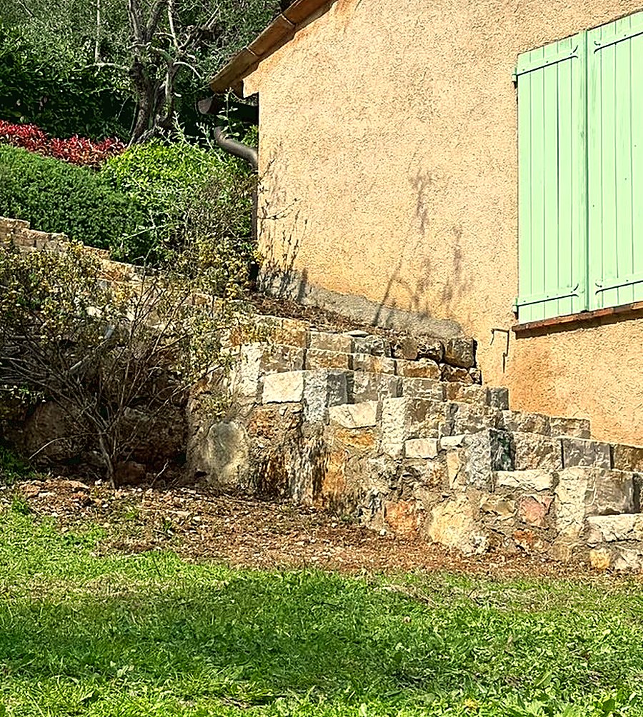 Mur de soutènement en pierre devant une maison provençale